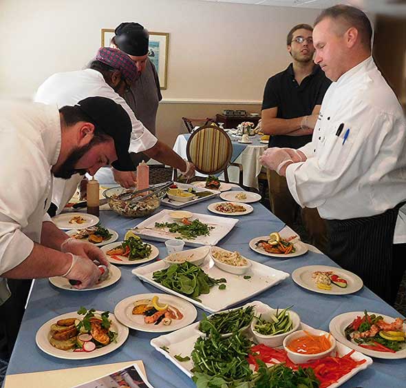 Photo of senior dining company crew preparing food service.